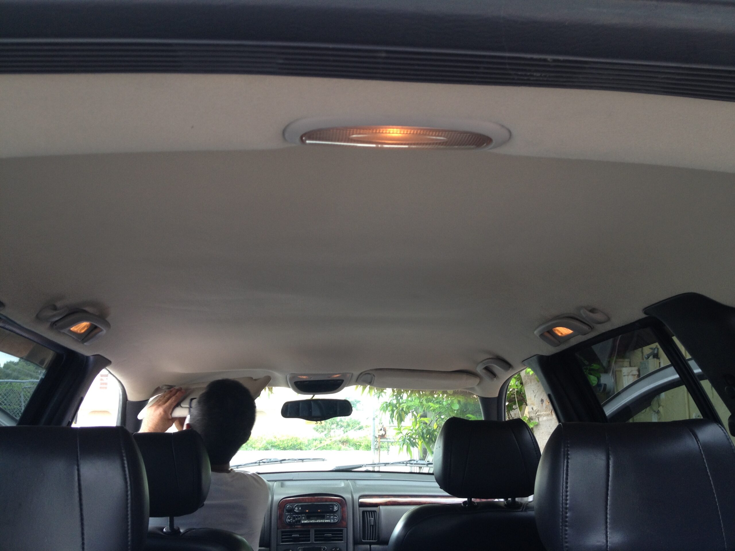 Chair Care Auto Headliner for SUV a person in a car fixing a headliner
